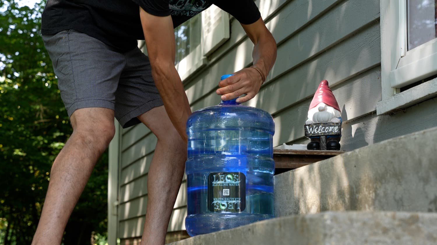 Leo delivering a 5-gallon jug to a customer's doorstep